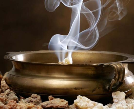 A copper bowl burning frankincense.