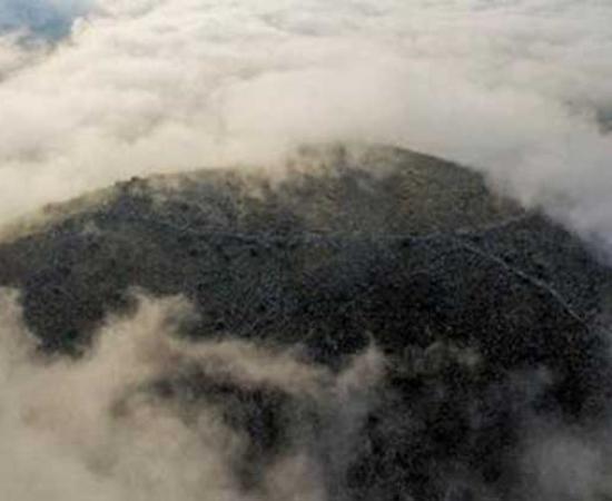The city’s acropolis is barely visible on the hill on a cloudy day. 
