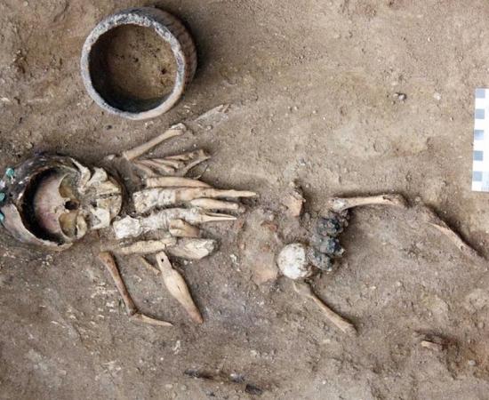 Infant discovered in 4,500-year-old burial mound with eight intricately carved figurines. The infant also wears headgear made from 11 copper plaques sewn together. 