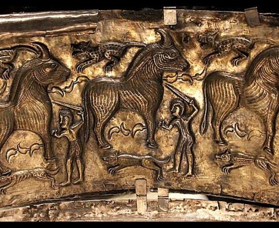 A panel from the Gundestrup Cauldron depicts three warriors sacrificing three bulls. The scene also features three hunting dogs and three felines, possibly leopards. 