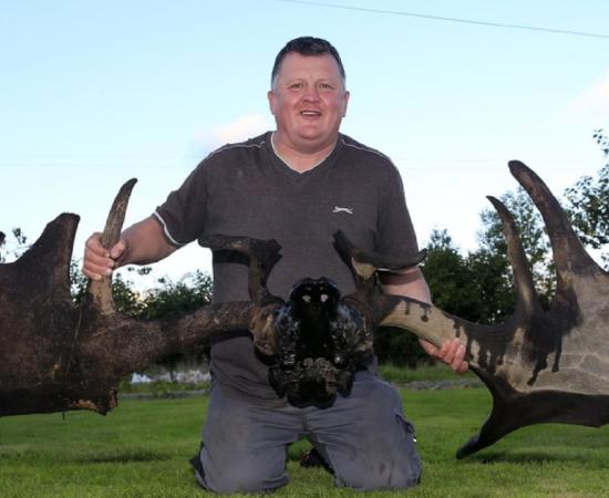 Raymond McElroy with the antlers and skull of an Irish Elk recovered from Lough Neagh