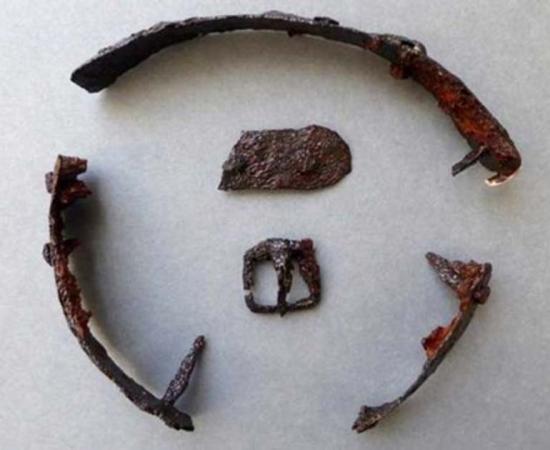 A buckle and part of a strap were found with the metal pieces. Credit: Border Archaeology