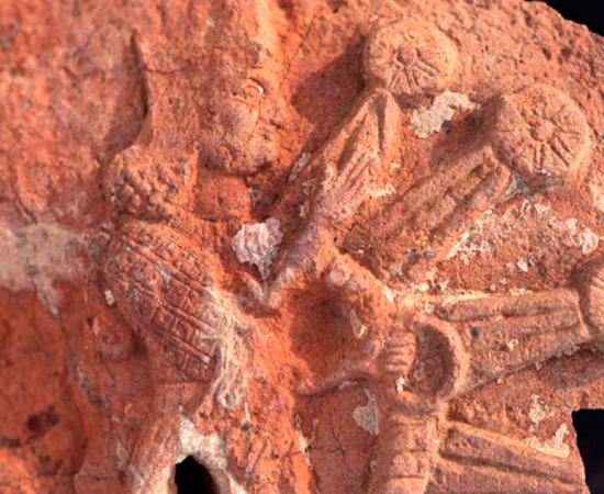 A fragment of the stone stele from the Ishtar temple. It depicts the goddess Ishtar inside a starburst with rosettes. Source: Penn Museum