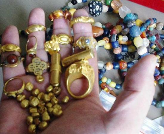 Handful of gold rings, beads and gold coins retrieved by fisherman in the River Musi and believed to be artifacts left behind by the Srivijaya Empire’s long-lost Island of Gold. Source: Wreckwatch Magazine