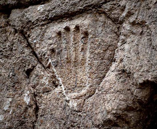 The mystery handprint was discovered on an ancient moat wall in the Old City of Jerusalem. Source: Yuli Schwartz / Israel Antiquities Authority