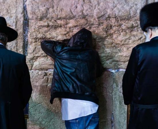 Three different Jewish people giving Selichot prayers at the Wailing Wall, Jerusalem 