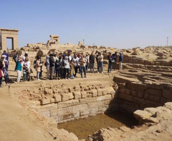 : Guests visit the ruins of the “sacred lake” at the Montu Temple precinct, Karnak, Luxor.