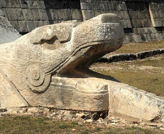 Kukulkan as a snake deity at the base of the west face of the northern stairway of El Castillo, Chichen Itza