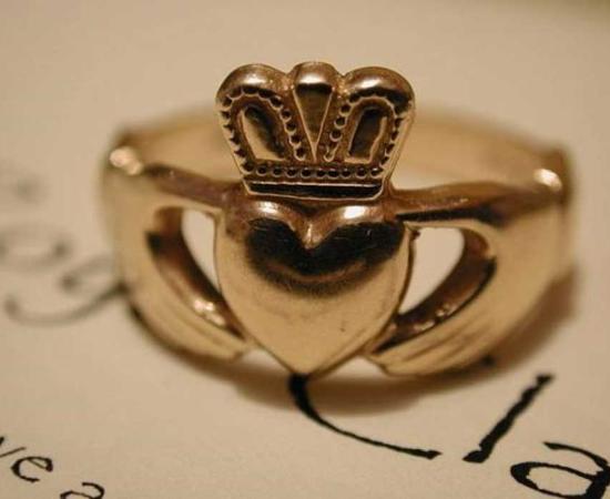 A gold Claddagh wedding ring. 