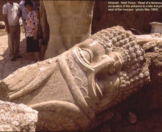 The now destroyed Nebi Yunus in Nineveh. Iraqi archaeologists excavate the monumental entrance to a late Assyrian building. The large head of a bull-man sculpture lies in a passageway.