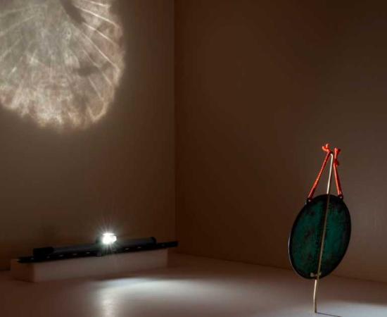 Demonstration of Buddhist Bronze Mirror reflecting its image at the Cincinnati Art Museum. Source: Rob Deslongchamps/Cincinnati Art Museum