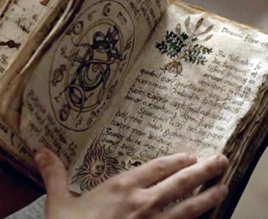 Person holding an ancient grimoire filled with spells, curses, and incantations