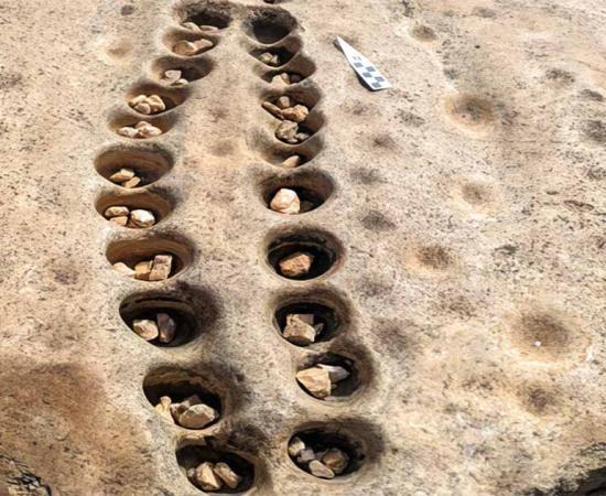 Rows of shallow pits drilled into rock are thought to be where ancient people played a version of the game Mancala.	Source: Courtesy of Veronica Waweru/Yale University