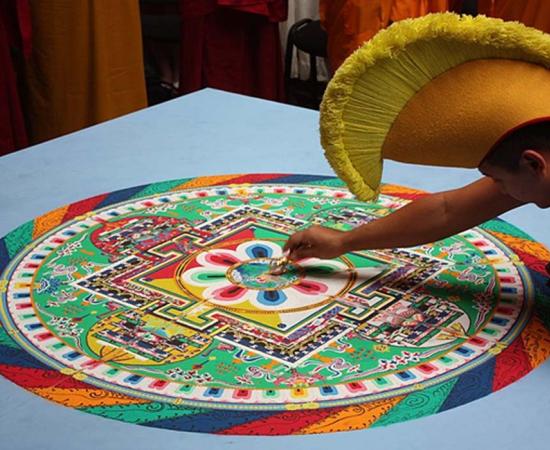 A Buddhist monk creating a mandala 