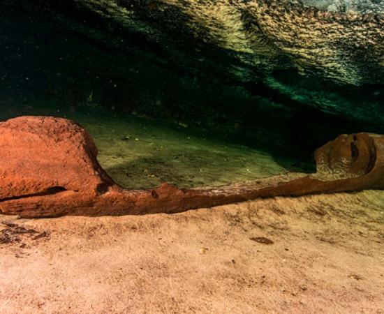 The underwater discovery of an ancient Maya canoe in a Mexican sinkhole. Source: INAH