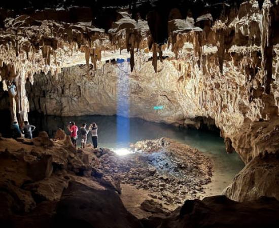 Tourists explore the 'Dome of the Cathedral', the largest chamber in Grutas Tzabnah, Yucatán, Mexico