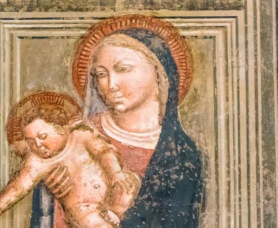 Fresco depicting the Virgin Mary holding Baby Jesus. Source: Giorgio G / Adobe Stock.
