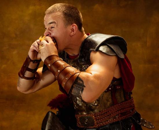Medieval soldier eating junk food. Source: master1305 / Adobe Stock.