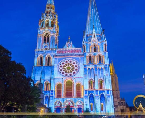The illuminated Our Lady of Chartres cathedral, France (kovalenkovpetr / Adobe Stock)