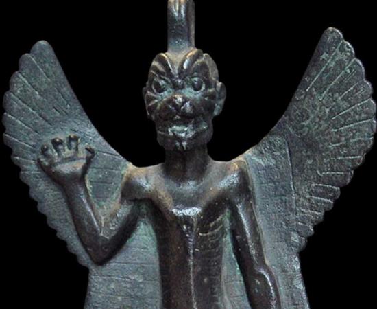 Detail of a bronze statuette of Pazuzu, circa 800 BC - circa 700 BC. Pazuzu was an Assyrian evil spirit believed to frighten away other evil spirits - protecting humans against plagues and misfortunes.