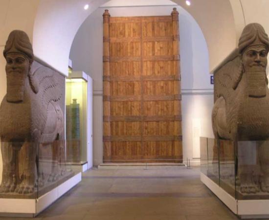 The British Museum - Room 6. Foreground: Assyrian Gateway Human Headed Winged Lions 'Lamassu' from the North West Palace of Ashurnasirpal II in Nimrud. 