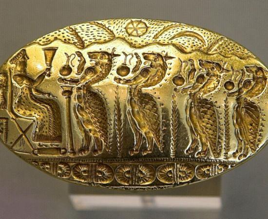 Mycenaean gold signet ring with a seated goddess and procession of Minoan genii, from Tiryns, Greece.