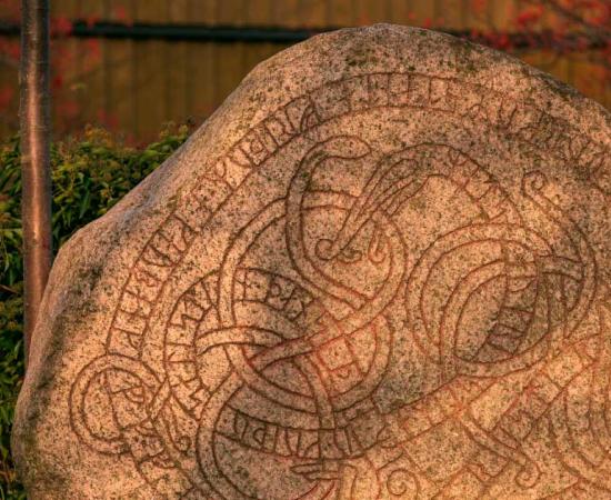 A large Viking rune stone depicting the Midgard serpent in Trelleborg Sweden. Source: Lars Gieger / Adobe Stock