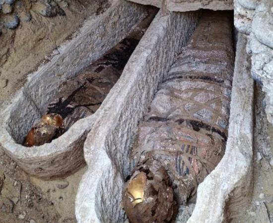 Mummies in sarcophagi at Al-Bahnasa, Egypt.