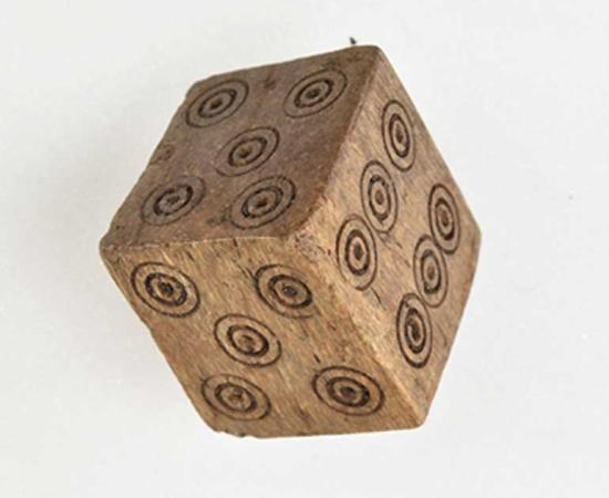 This Medieval dice has two 4's and two 5's but no 1 or 2. Archaeologists believe that it was likely used to cheat while gambling. This photo shows the two 5's. 