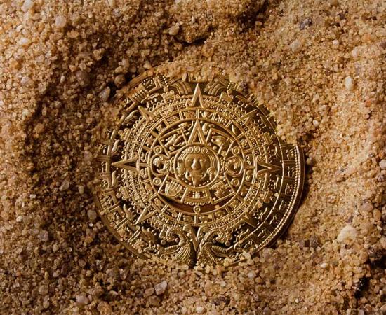 Aztec coin in sand. Source: breakermaximus / Adobe Stock.