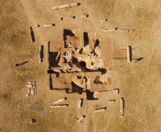 Drone aerial shot of the ancient Turkish ruins on Dongoin shiree. (North at the top.) Segments of the inscriptions and sarcophagus excavated from the hole at the center of the ruins can be seen.