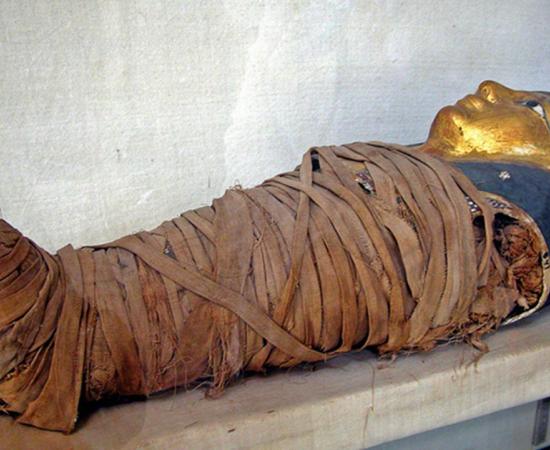 Mummy of a child with a gilded face mask. Greco-Roman Museum, Alexandria, Egypt. Representational image only.