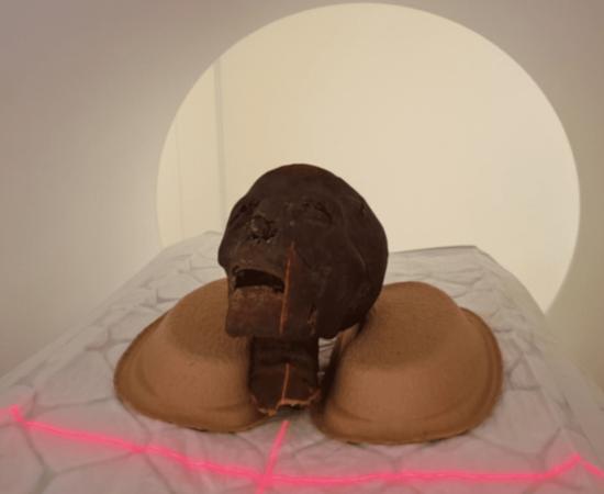 A mummified head going through a CT scanner.