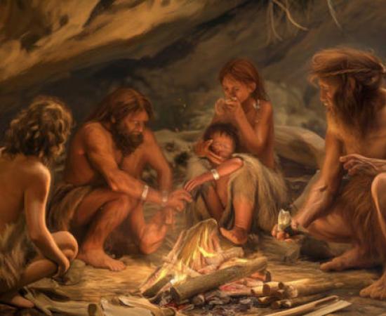 Representation of Neanderthals in a cave around a fire.