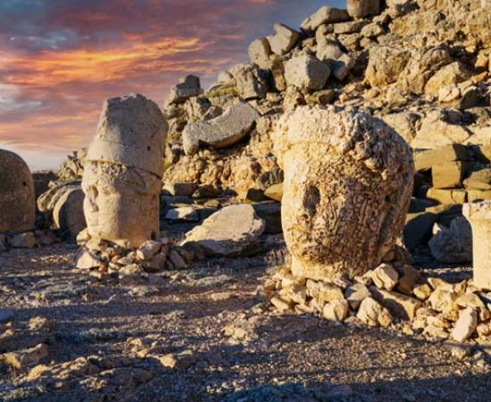 Nemrut Mountain at 2150 meters with colossal statues, and stone heads. A UNESCO World Heritage site. Anatolia, modern day Turkey. 	Source: Bulent/Adobe Stock