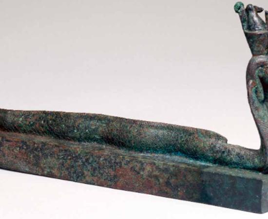 Animal coffin EA36151, surmounted by a human-headed part-eel, part-cobra creature wearing a double crown, associated with the ancient Egyptian god Atum. Source: The Trustees of the British Museum/Nature