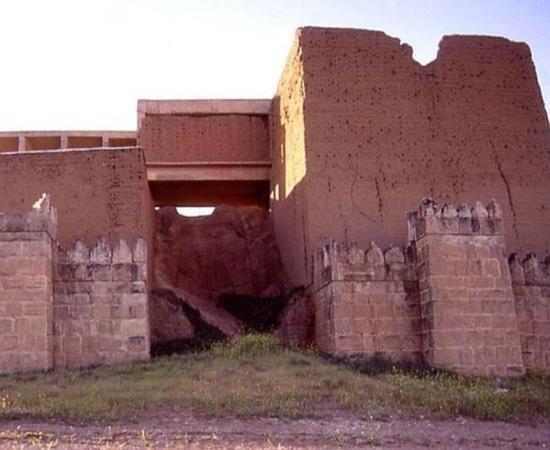 One of the fifteen gateways of ancient Nineveh. A reconstruction was begun in the 1960s by Iraqis, but was not completed. The lower portions of the stone retaining wall are original.
