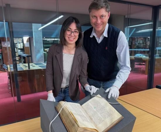 : Dr Elisabetta Magnanti and Dr Mark Faulkner with the Trinity copy of Bede’s Ecclesiastical History