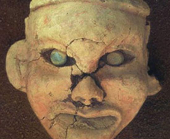Painted clay goddess face with eyes inset with jade, found at Goddess Temple, Niuheliang.