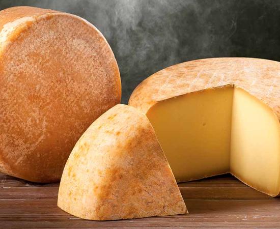 Parmesan cheese on a smoky background. Source: AnneMarie / Adobe Stock