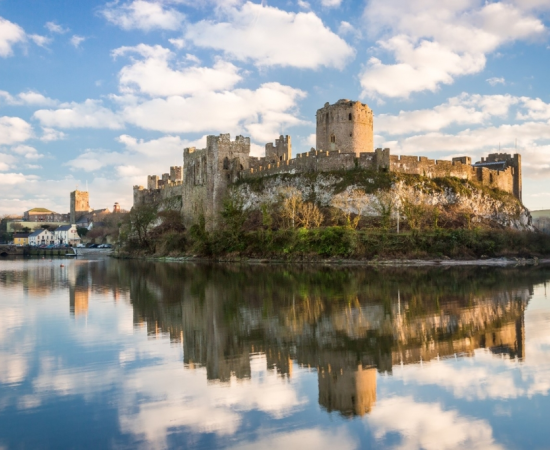 Pembroke Castle in Pembrokeshire, Wales. Archaeologists from the University of Aberdeen are excavating Wogan Cavern beneath the medieval fortress, where preserved sediments contain evidence of human occupation and environmental change stretching back more than 100,000 years