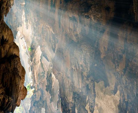 Ray of sunlight entering a rock chamber, representational. Source: Lina / Adobe Stock.