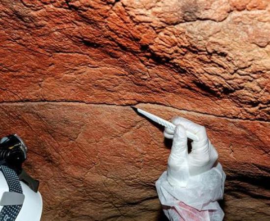 Pigment sampling at a claviform rock art figure in Tebellín, Spain