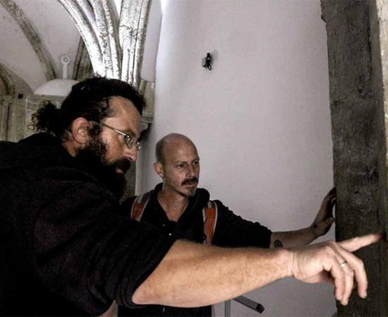 Researchers at the Tomb of David building, examining what they hope is the mark of Adrian von Bubenberg.	Source: IAA