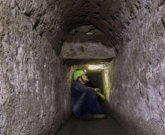 Tunnel within ancient Pompeii’s drains system with archaeologist inside.       Source: Archaeological Park of Pompeii 
