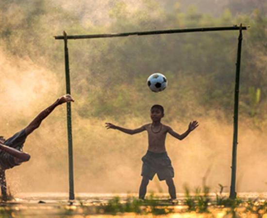 Children playing football in Thailand