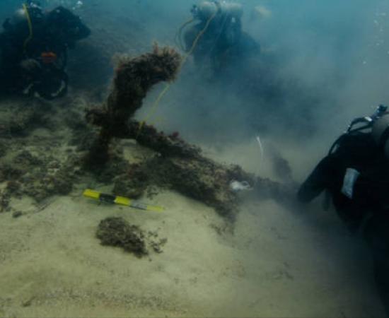 Divers exploring the submerged ancient structures off the coast of Taposiris Magna 