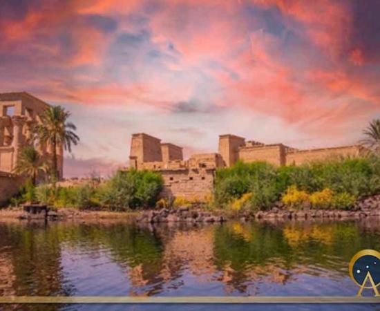 Incredible orange sunrise at the temple of Philae, a Graeco-Roman construction seen from the Nile river, a temple dedicated to Isis, goddess of love. (unai/Adobe Stock)