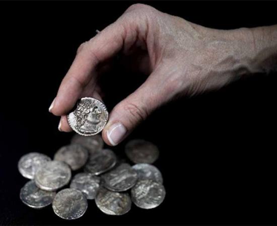 The hoard of fifteen tetradrachm were found in a wooden container lined with sheepskin and cloth (Israel Antiquities Authority)