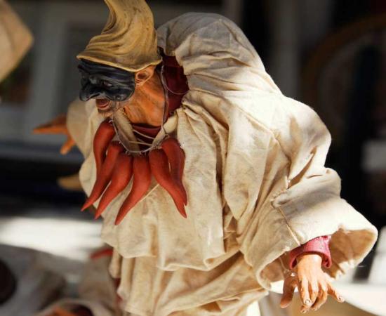 A figurine of Pulcinella with his mask 